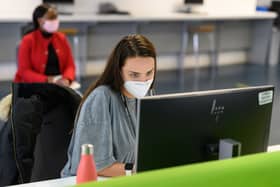 Students, wearing face masks to help mitigate the spread of coronavirus COVID-19, work on computers in the Social Learning Zone at the University of Bolton (Photo by OLI SCARFF / AFP) (Photo by OLI SCARFF/AFP via Getty Images)