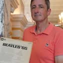 Max Bass pictured holding the Beatles album which his mum got the Beatles to sign in 1965.