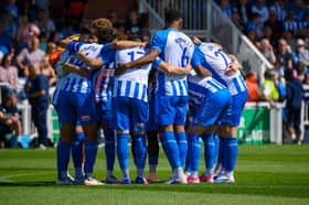 Hartlepool United players in a huddle before their home win against National League rivals Barrow.
