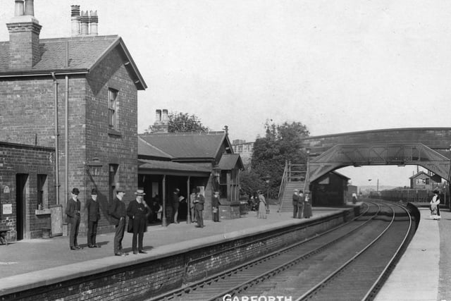 View of the platform looking west at Garforth Railway Station. In the centre is the road bridge on Aberford Road, unusual in that it is built at a slanting angle.