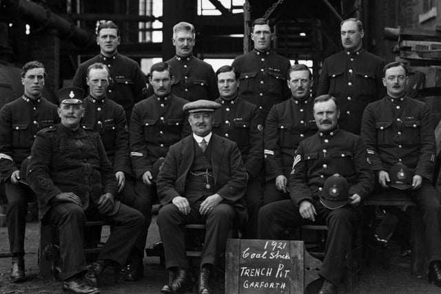 Police officers called in to Garforth Trench Pit due to a coal strike with the sergeant to the right and what is believed to be the foreman of the pit at the centre next to a sign with the year. The strike was caused by poor working conditions and a flood disaster.