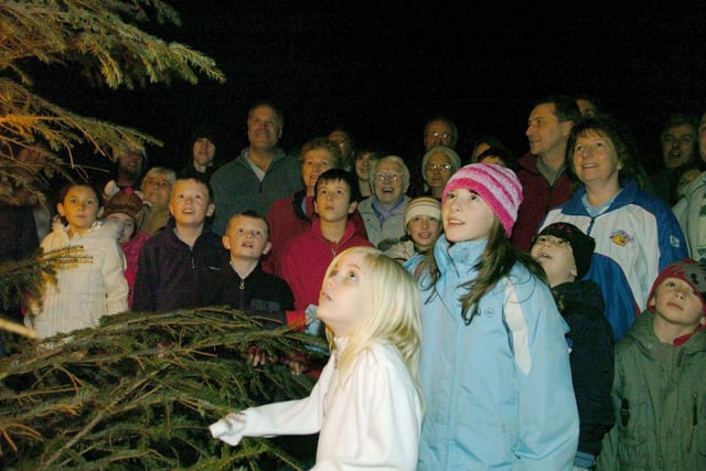 Villagers singing carols  at the Kirkhamgate Christmas tree in the centre of the village