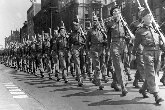 Soldiers seen here are marching down The Headrow in 1942 as part of the Ark Royal Parade.