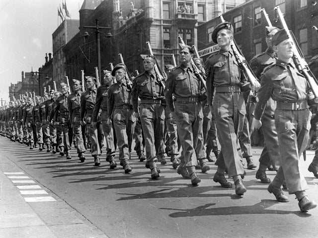 Soldiers seen here are marching down The Headrow in 1942 as part of the Ark Royal Parade.