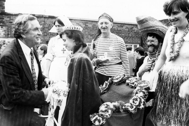 Gipton Gala in July 1986. Denis Healey MP crowns Gala Queen Ann Marie Duffywatched by local people in fancy dress costumes.