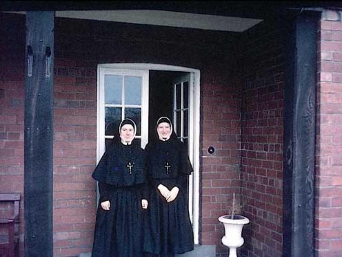 May 1967. Two sisters of the Holy Family of Wetherby stand in front of the entrance of the convent adjoining St. Joseph's Catholic Primary. The sisters of the Holy Family originated from Mount St. Mary's in Leeds and came to Wetherby in the 1930s.