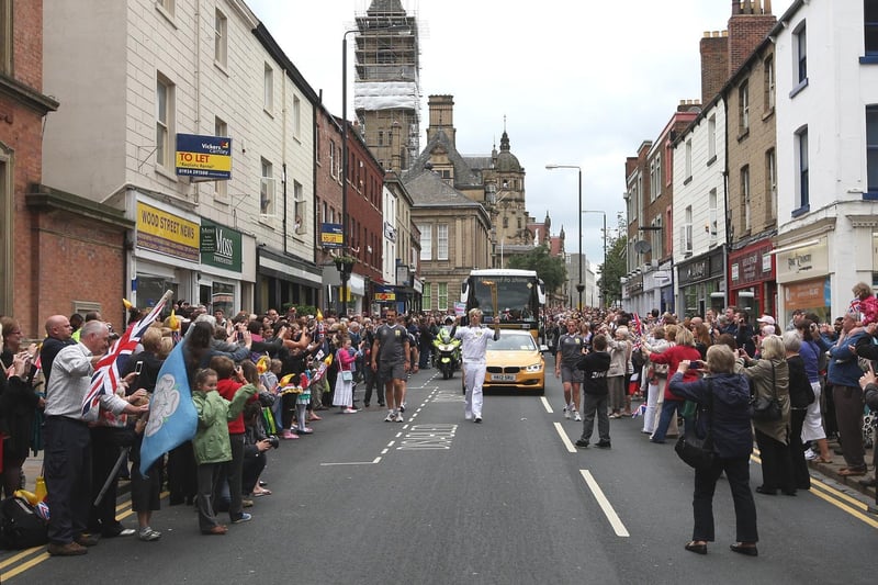 The torch procession travels along Wood Street, in Wakefield city centre.