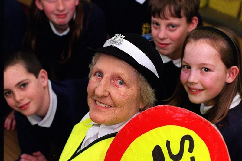 Lollipop lady Kath Stone retired after 32 years. She is pictured with some of the pupils at Victoria Junior and Infant School.