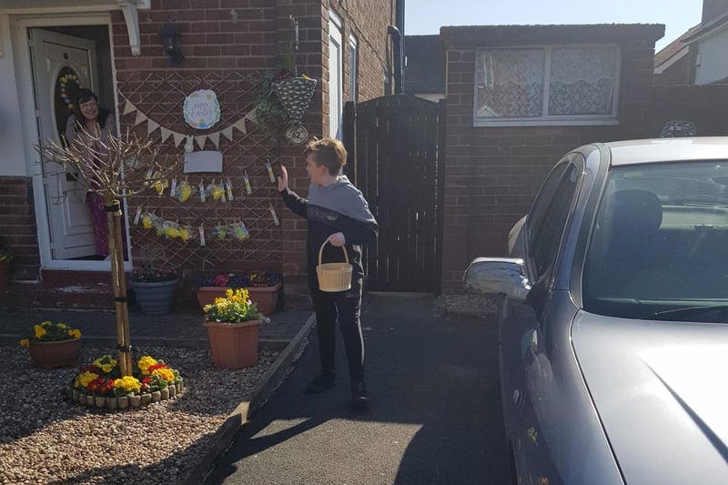 This youngster collects his treat and waves a friendly 'hello' to a resident