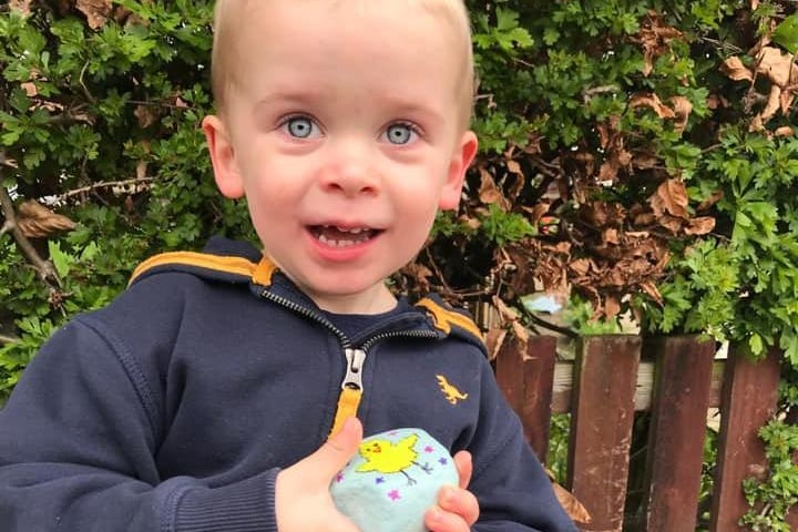 Three-year-old Reuben with a rock he found