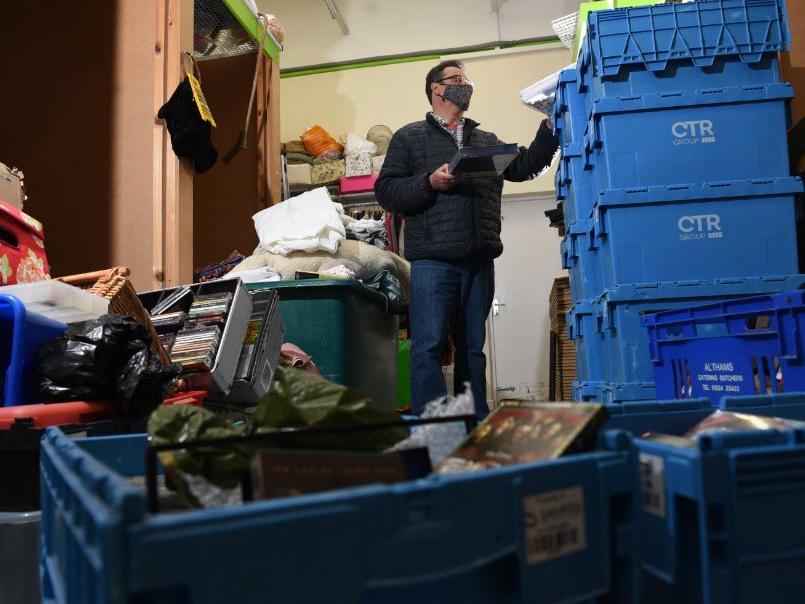 Graham Strong sorts through donations at Barnardo's Charity Shop at Ashton