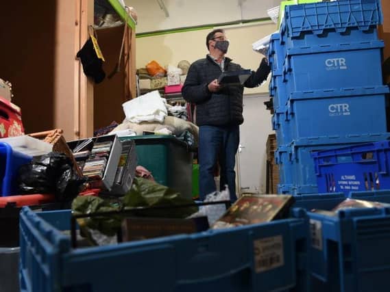 Graham Strong sorts through donations at Barnardo's Charity Shop at Ashton