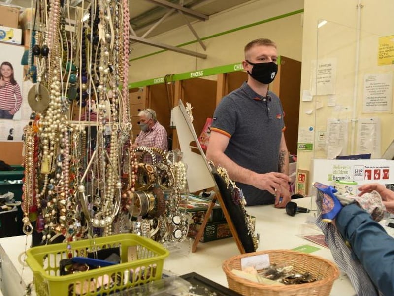 Jordan Whittaker accepts people's donations at Barnardo's, Ashton