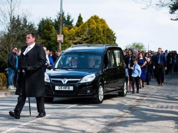 A line of mourners, including fellow pupils from John Cross C of E Primary School followed the hearse