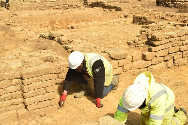 Archaeologists work on a wall at the site in Scarborough.