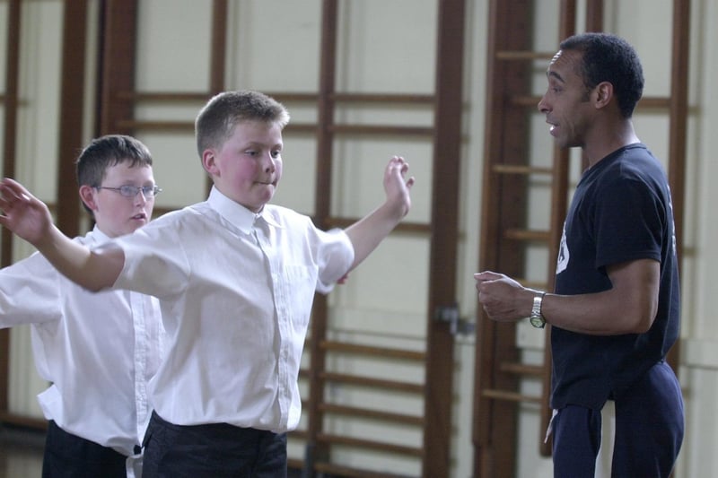 Pupils Sean Ramsden (left) and Thomas Gaffigan (right) are taught Street Dance  by Jason James from the RJC Dance Company in May 2001.