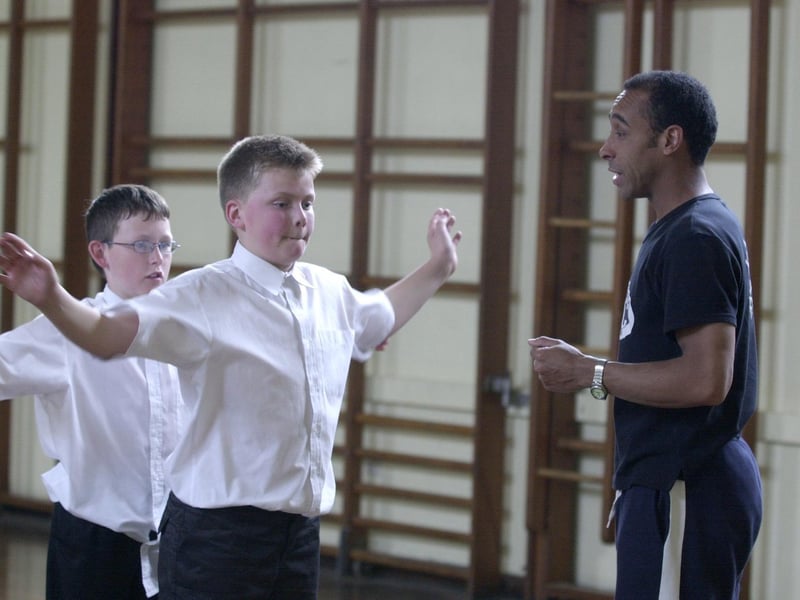 Pupils Sean Ramsden (left) and Thomas Gaffigan (right) are taught Street Dance  by Jason James from the RJC Dance Company in May 2001.