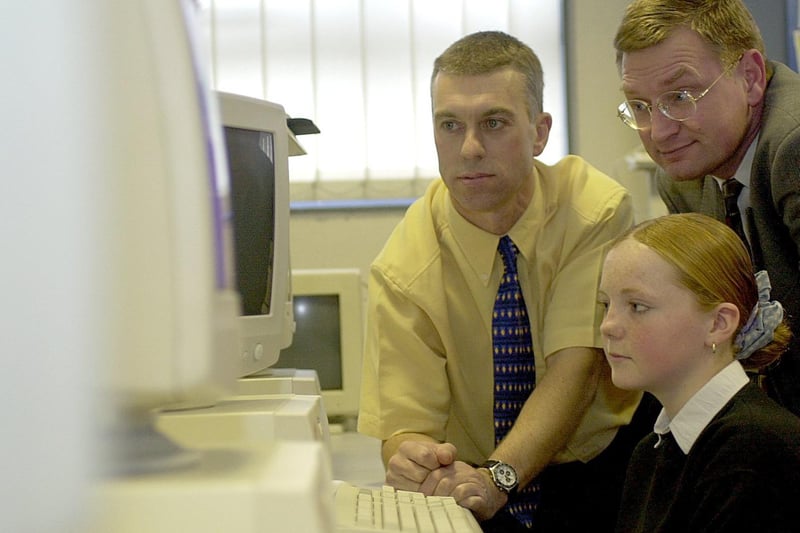 November 2000 and British Gas donated computers to the school . Pictured is Dirk Vennix (glasses) from British Gas with  with pupil Charmaine Frudd and IT coordinator Graham Suggitt.