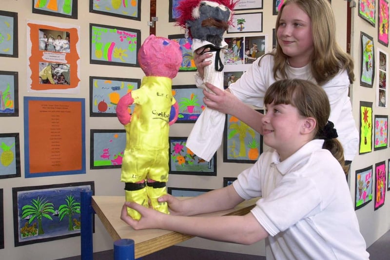 Pupils Charlotte Winter (top) and Lisa Cole admire their art puppets as part of SPARK (sport and art towards knowledge) project at West Yorkshire Playhouse in April 2001.