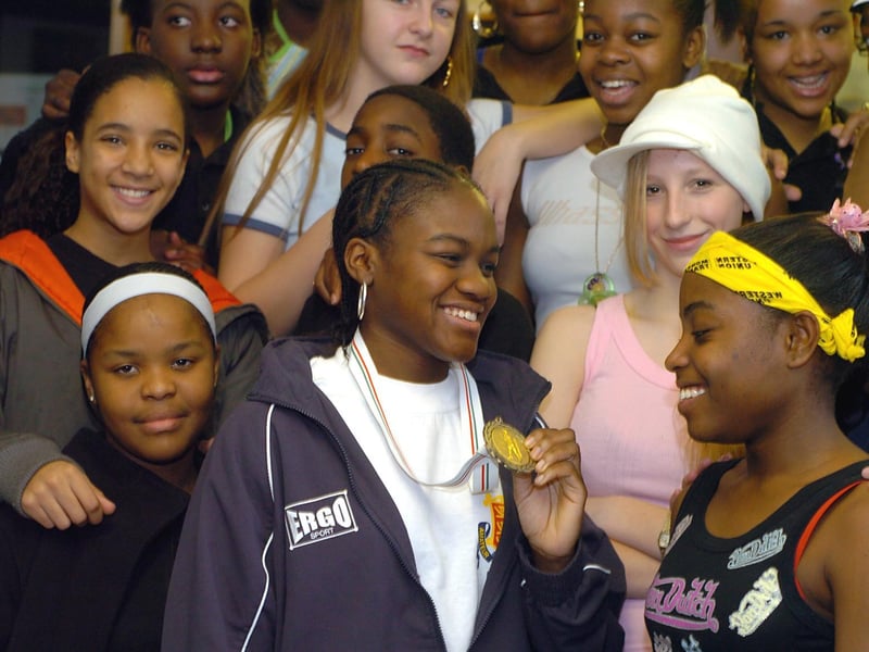 December 2004 and boxer and former pupil Nicola Adams shows the gold medal she won as English amateur champion on a visit to the school.