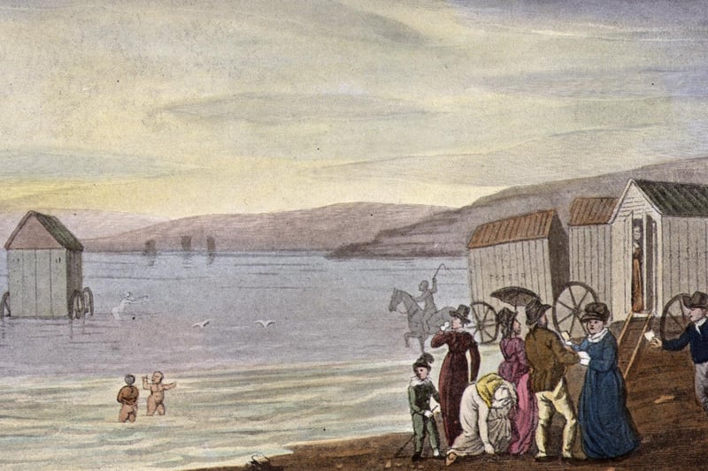 circa. 1813. A huddle of bathing machines trundle into the sea at Scarborough, allowing demure tourists to swim in total privacy. 
Original Artwork: A print by J Green from Ackermann's 'Poetical Sketches of Scarborough'.
