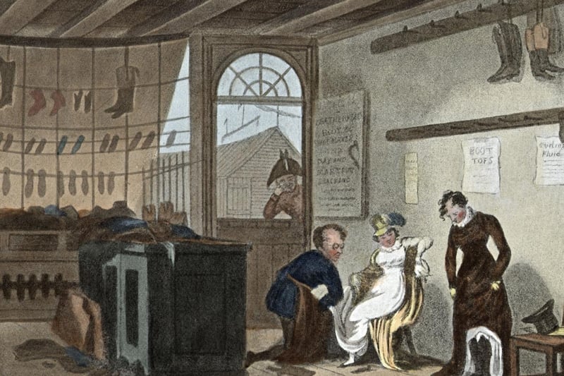 An assistant helps customers in a boot and shoe shop. Original Publication: Political Sketches of Scarborough - pub. 1813