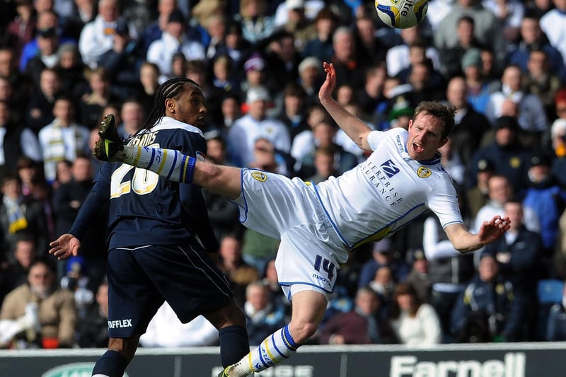 Aidy White tangles with Huddersfield Town's Neil Danns during the Chamionship clash at Elland Road in March 2013.
