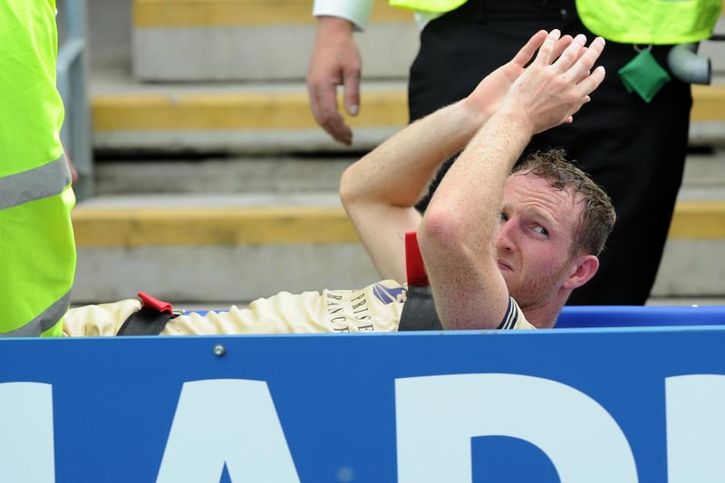 Aidy White applauds the travelling Leeds fans as he's stretchered off the pitch during a pre-season friendly against Chesterfield in July 2014.