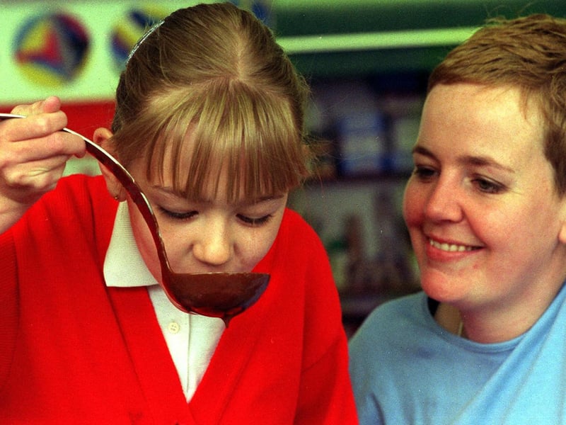 June 2000 and artist Kate Genever carries out a chocolate tasting session with Roseanne Beney at Raynville Primary.