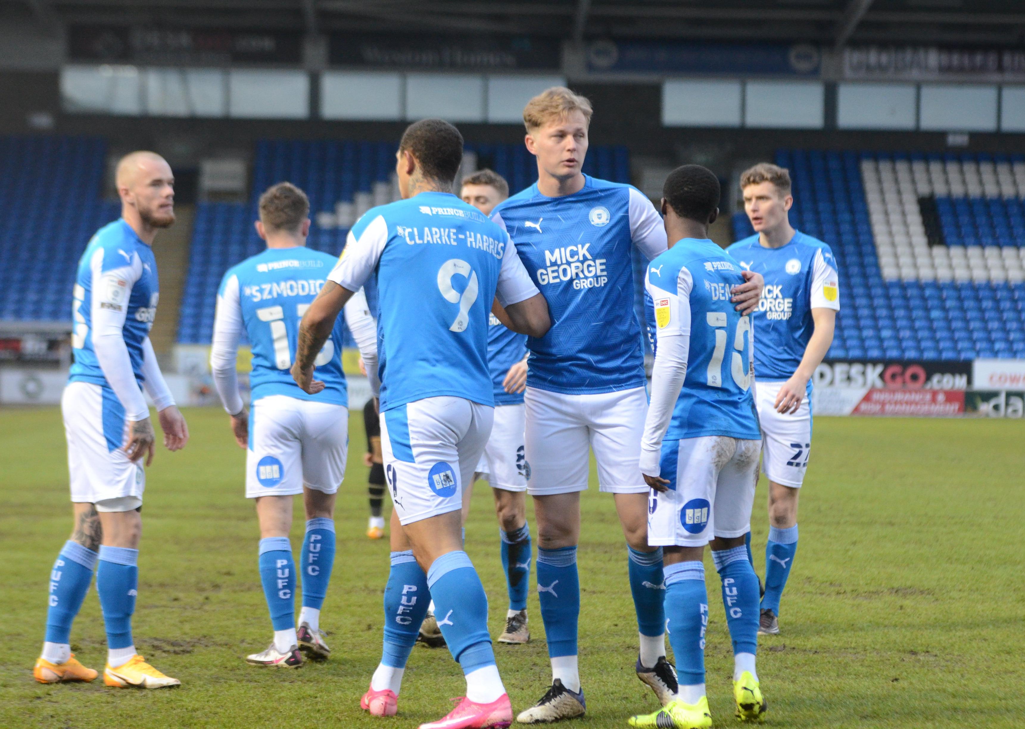 Posh players celebrate a goal against MK Dons on Saturday. Photo: David Lowndes.