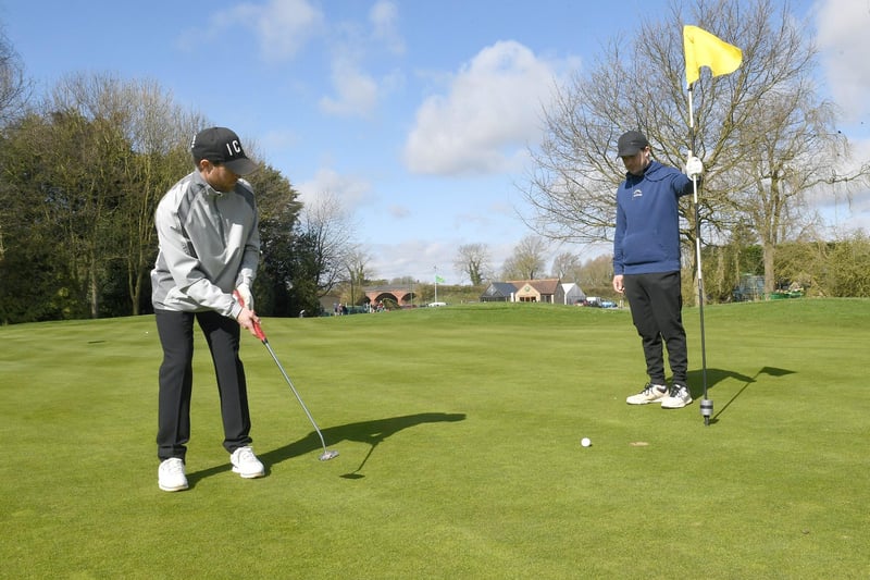 Sudbrook Moor Golf Club. Jacob Johnson and James Johnson of Lincoln on the 18th green. EMN-210329-163144001