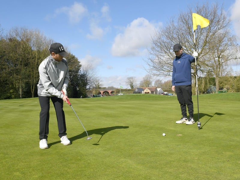 Sudbrook Moor Golf Club. Jacob Johnson and James Johnson of Lincoln on the 18th green. EMN-210329-163144001