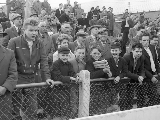 One fan can be seen here with a football rattle, an item which would come to be banned from grounds.