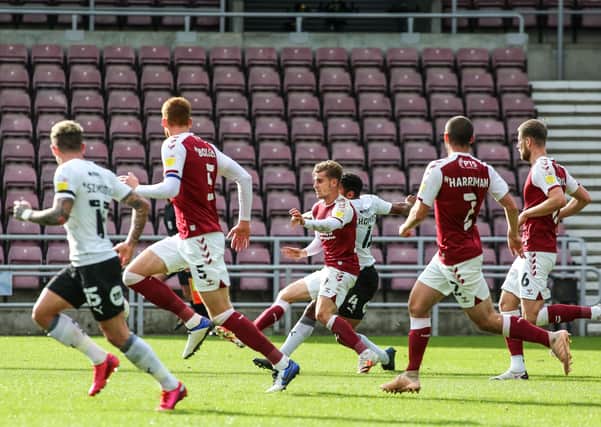 Nathan Thompson (hidden) scores for Posh at Northampton at Sixfields in October.