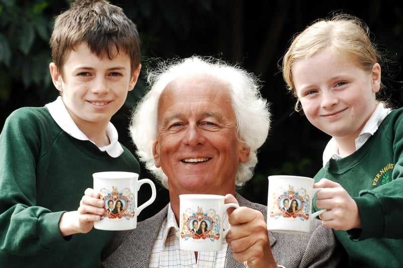 Children of Fernhurst Primary School with parish council chairman James Cottam and their royal wedding mugs. Picture: Bill Shimmin C110676-2