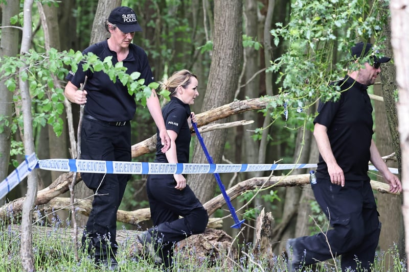 Police teams searching the area after finding a body. SUS-210206-145119001