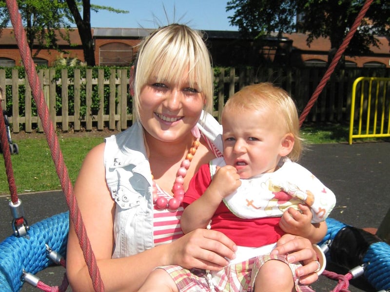 Keeley Dawson, with son Freddie, 17 months, try out
the new ‘nest’ swing in the children’s playground.