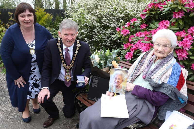 Margaret Mitchel, who celebrated her 100th birthday on  April 26, receives her commemorative coin from the Mayor of Causeway Coast and Glens Borough Council Alderman Mark Fielding and Mayoress Mrs Phyllis Fielding
