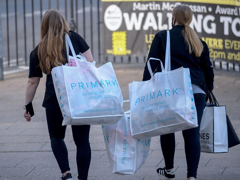 Early morning shoppers heading home on Friday as non-essential retails outlets reopen. Photo: George Sweeney / Derry Journal. DER2117GS – 036