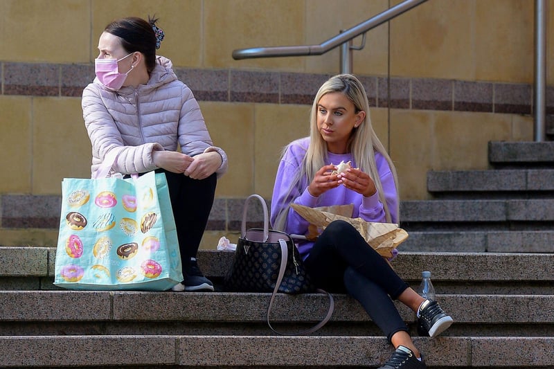 Taking a break from shopping on Friday morning as non-essential retails outlets reopened. Photo: George Sweeney / Derry Journal.  DER2117GS - 043