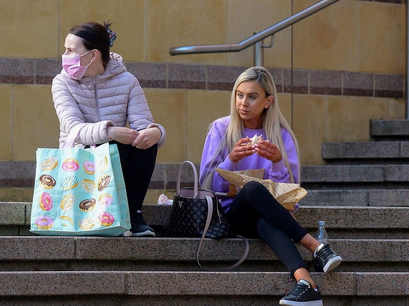 Taking a break from shopping on Friday morning as non-essential retails outlets reopened. Photo: George Sweeney / Derry Journal.  DER2117GS - 043