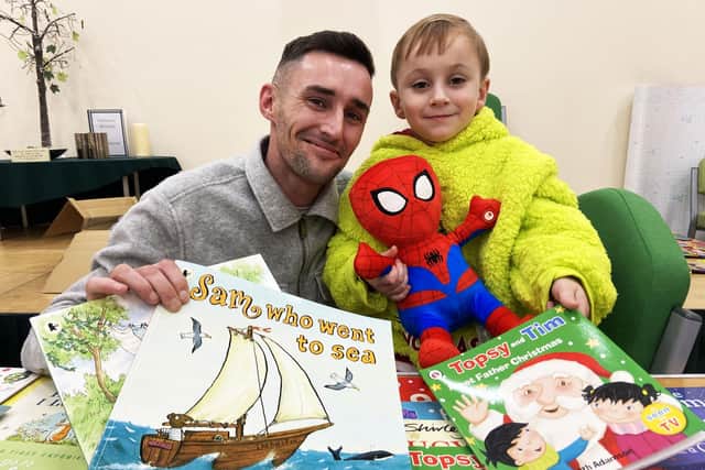 Matthew Cormack (31) with his son Matthew (4) as they pick their books at the St. Aidan's CE Memorial Primary School Christmas book fair.