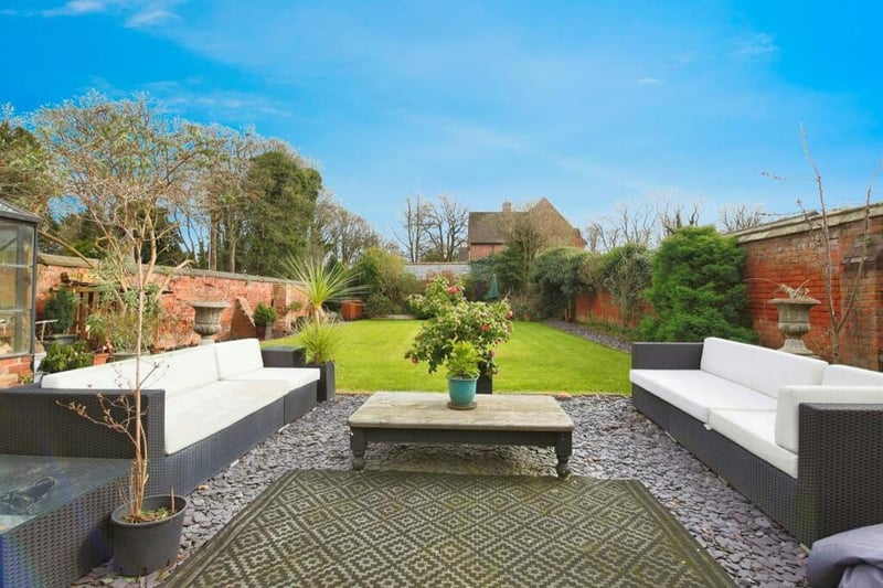 This home has a beautiful rear garden featuring a slate patio area, paved area to the side and greenhouse.