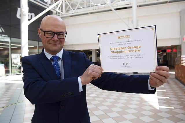 Middleton Grange Shopping Centre Manager Mark Rycraft with the certificate.