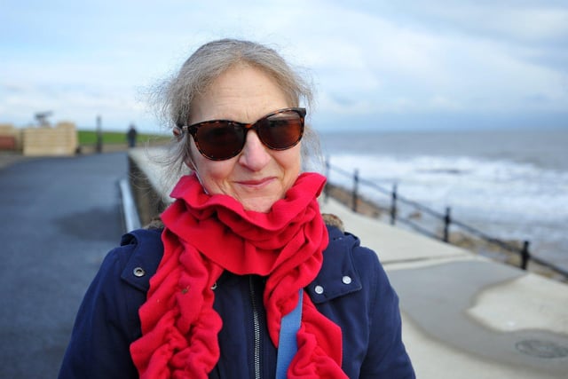 Karen Piercy dons a lovely red scarf and sunglasses as she takes a stroll on the Headland.