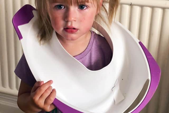 Clodagh-Mae Cafferkey with her toilet trainer over her head.
