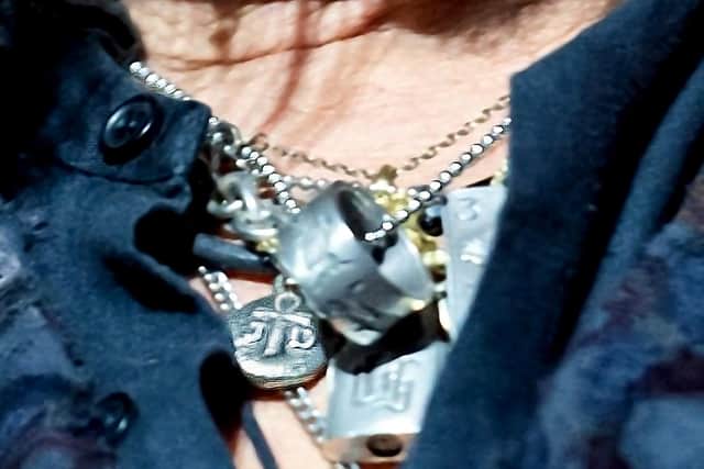 A close-up photo shows Depp wearing the pendant.