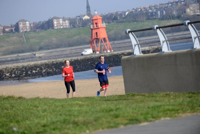Joggers take their exercise at Littlehaven beach