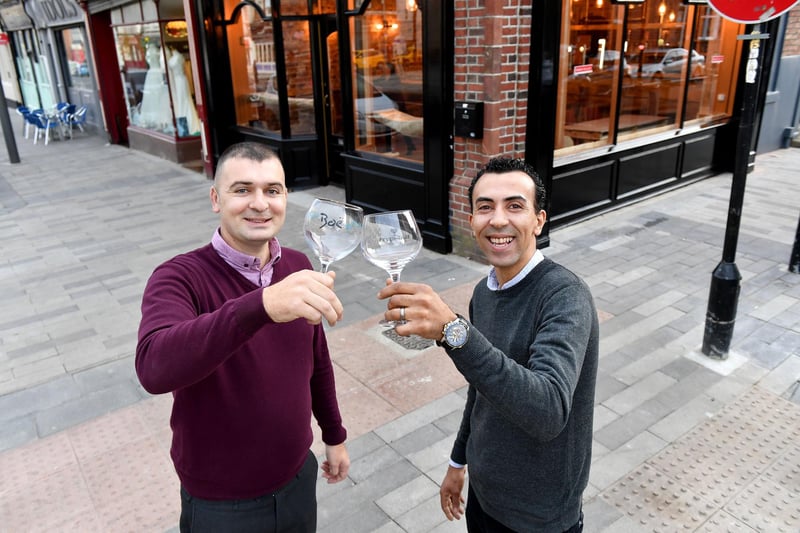 Stephen Collinson, left, and Amro Fathy Galal Selim celebrate the opening of their Church Street wine bar in 2018.