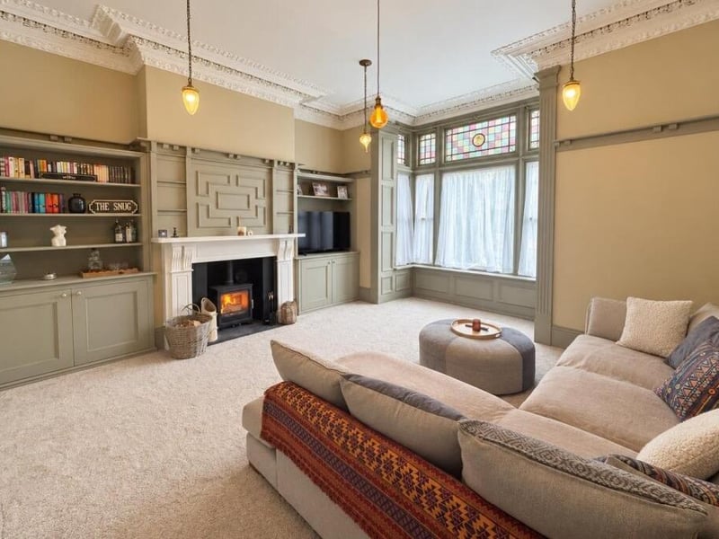 This large lounge is located at the front of the home and has an original square bay window. This room also benefits from a marble fire surround.